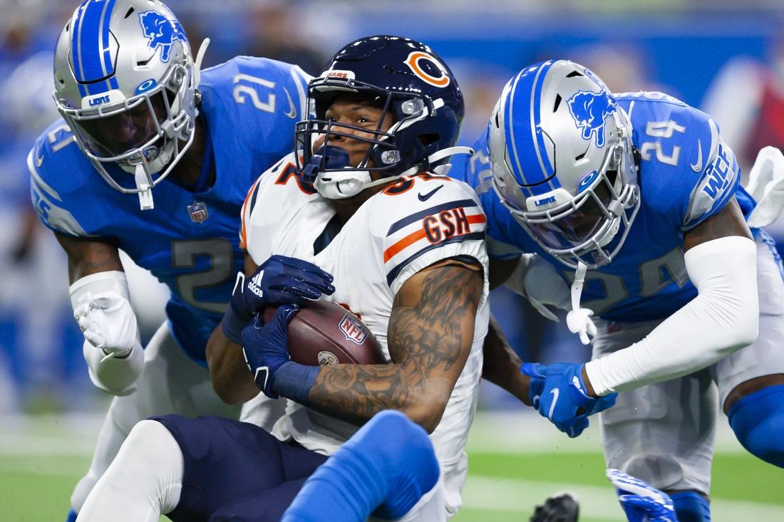 Chicago Bears running back David Montgomery (32) gets tackled by Detroit Lions cornerback Amani Oruwariye (24) and free safety Tracy Walker III (21) during the first quarter at Ford Field, in Detroit, on Nov. 25, 2021. (Raj Mehta/USA TODAY Sports via Field Level Media)