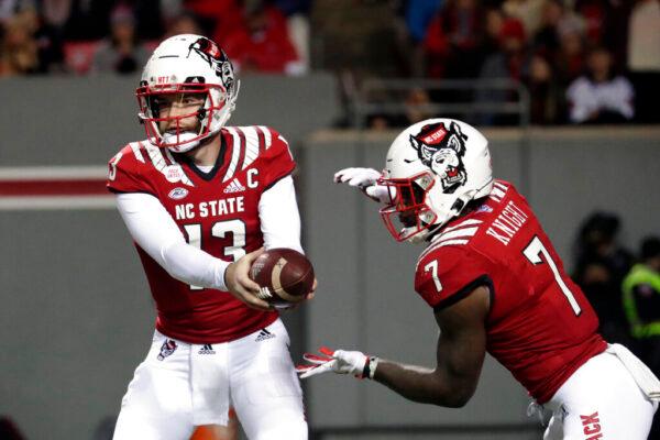 North Carolina State quarterback Devin Leary (13) hands off to running back Zonovan Knight (7) during the first half of the team's NCAA college football game against North Carolina in Raleigh, N.C., on Nov. 26, 2021. (Chris Seward/AP Photo)