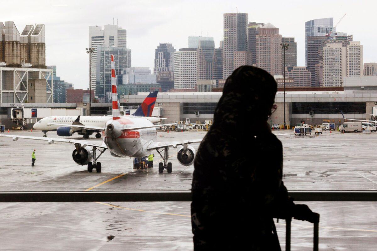 Delta Airlines and an American Airlines planes taxi away from their gate ahead of the Thanksgiving holiday at Logan International Airport in Boston, Mass., on Nov. 22, 2021. (Brian Snyder/Reuters)