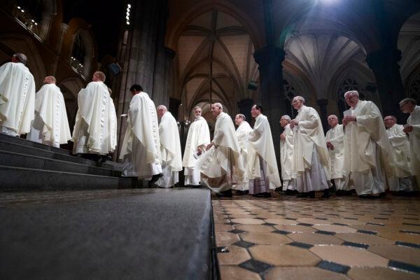 Dozens of Bishops walk the aisle to start a mass at St Patrick's Cathedral in Melbourne, where the new Archbishop of Melbourne, Peter Comensoli, is officially installed in East Melbourne, Australia, on Aug. 1, 2018. (AAP Image/Daniel Pockett)