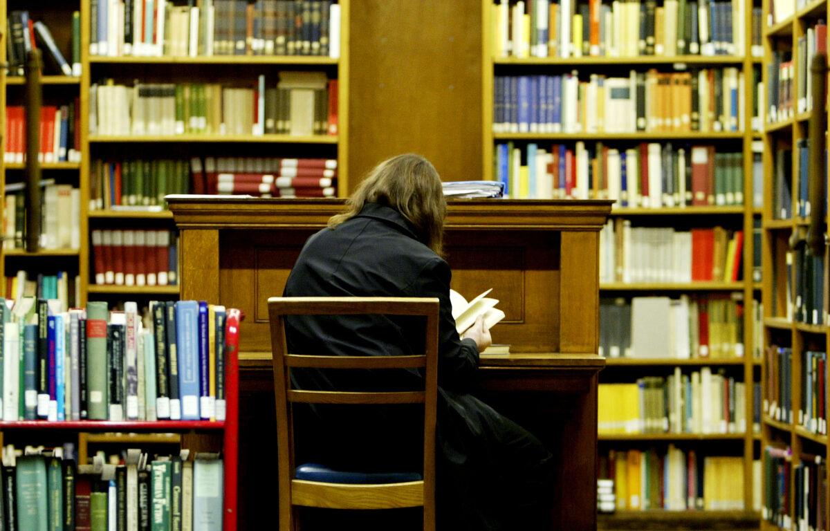 A student studies in the main library at the University College London in London on Dec. 1, 2003. (Ian Waldie/Getty Images)