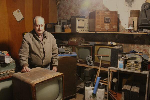 Joe Spanel is closing his family’s electronics repair business after 75 years in Dayton, Ohio. Spanel is pictured on Nov. 28 in a back room of the shop with 1950s-era television sets—RCA Victors and Motorolas—that have long been obsolete. (Photo by Michael Sakal)