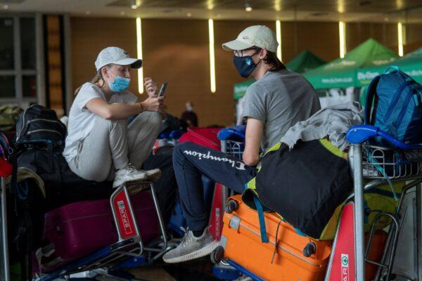 Students from Norway who were on a field trip to South Africa wait to be tested for COVID-19 before boarding a flight to Amsterdam at Johannesburg's OR Tambo's airport in South Africa on Nov. 29, 2021. (Jerome Delay/AP Photo)