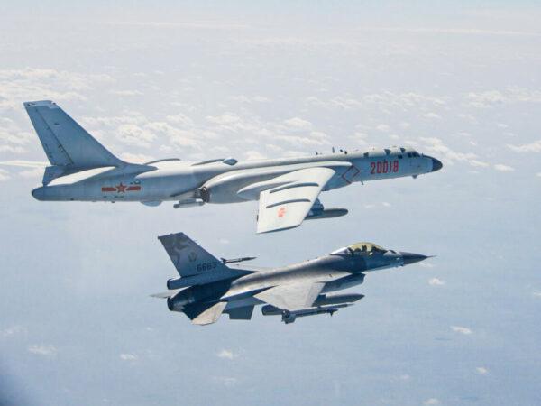 An H-6 bomber of Chinese PLA Air Force flies near a Taiwan F-16 in this Feb. 10, 2020 handout photo provided by Taiwan Ministry of National Defense. In a statement, the ministry said Chinese J-11 fighters and H-6 bombers flew into the Bashi Channel to the south of Taiwan, then out into the Pacific before heading back to base via the Miyako Strait. (Taiwan Ministry of National Defense/Handout via Reuters)