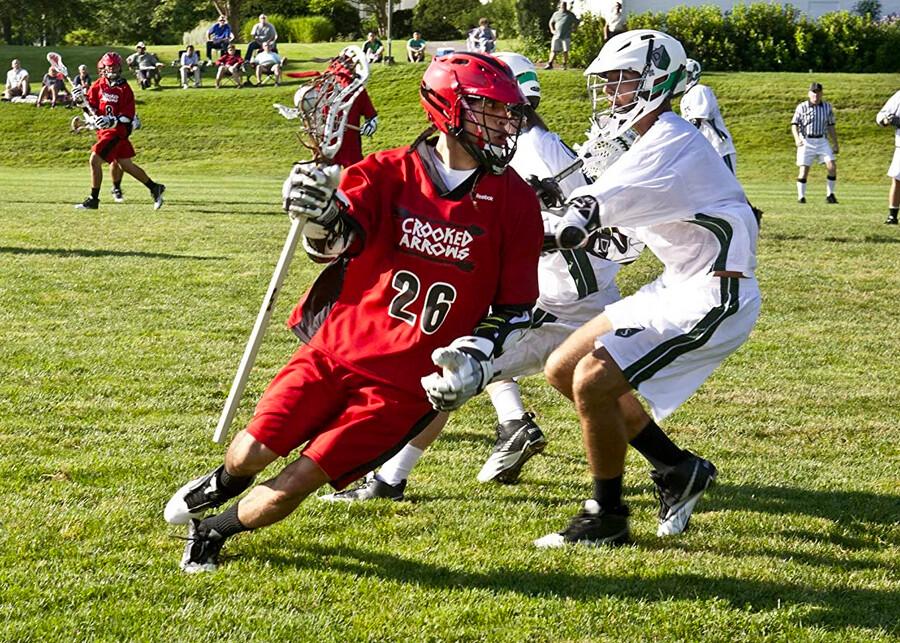 Jimmy Silverfoot (Tyler Hill) plays attack position against an opposing team player, in "Crooked Arrows," about a Native American high school lacrosse team making it to a prep school league tournament. (Kent Eanes/Peck Entertainment/20th Century Fox Home Entertainment Freestyle Releasing)