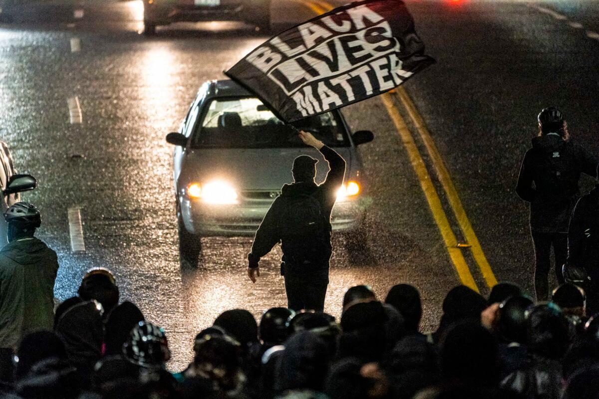 A protester waves a Black Lives Matter flag in Seattle on Nov. 3, 2020. (David Ryder/Getty Images)