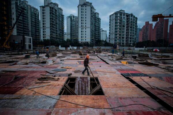A man works at a construction site of a residential skyscraper in Shanghai on Nov. 29, 2016. (JOHANNES EISELE/AFP via Getty Images)