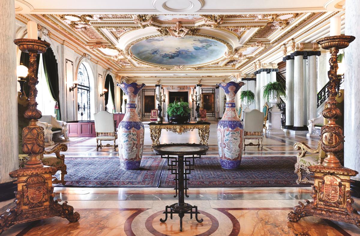 The Grand Hall: The New York firm of Pottier & Stymus designed the interiors of Whitehall. The bold marble columns and ornate plaster moldings on the ceiling, highlighted with gold leaf, define the Grand Hall and welcome guests upon arrival. (Flagler Museum)