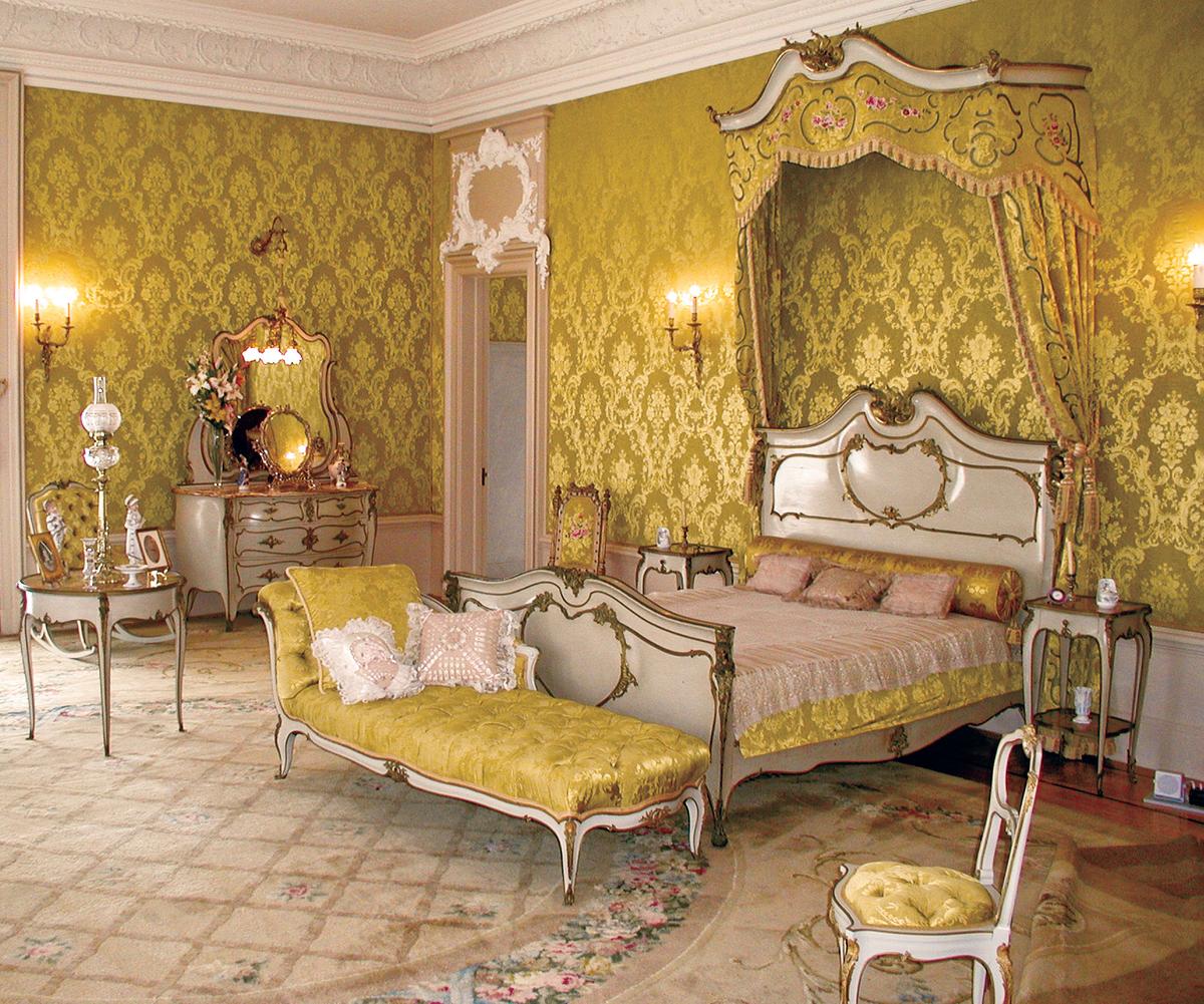 Decorated in the Louis XV style, the Master Suite is adorned with gold-colored silk fabric, creating a nourishing haven that almost glows. (Flagler Museum)