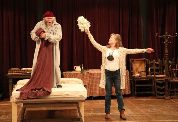 Richard Doyle (L) plays Ebenezer Scrooge with his wife Jennifer Parsons as the Ghost of Christmas Past in A Christmas Carol by Charles Dickens adapted by Jerry Patch and directed by Hisa Takakuwa, at South Coast Repertory in Costa Mesa, Calif., from Nov. 27 to Dec. 26, 2021. (Nicholas Pilapil/SCR)