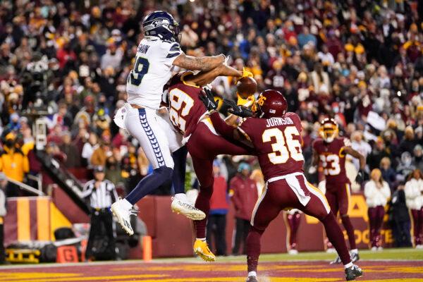 Washington Football Team cornerback Kendall Fuller (29) intercepts a pass in the end zone intended for Seattle Seahawks wide receiver Freddie Swain (18) during the second half of an NFL football game in Landover, Md., on, Nov. 29, 2021. (Julio Cortez/AP Photo)