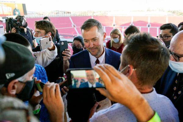 Lincoln Riley, center, the new head football coach of the University of Southern California, answers questions from reporters after a ceremony in Los Angeles on Monday Nov. 29, 2021. (Ashley Landis/AP Photo)