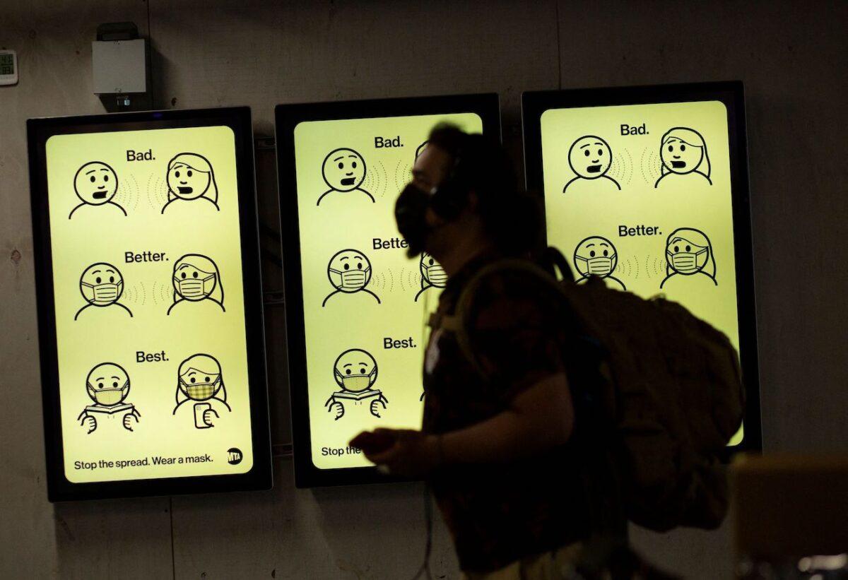 A sign displays mask wearing information at Penn station in New York on Aug. 2, 2021. (Kena Betancur/AFP via Getty Images)