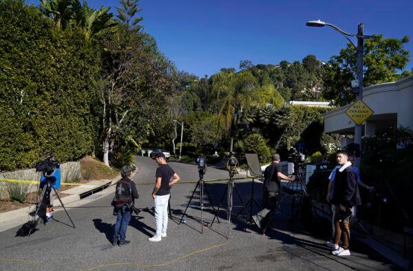 Media gather at the intersection of Maytor Place and Barrie Drive in the Trousdale Estates section of Beverly Hills, Calif., on Dec. 1, 2021. (Chris Pizzello/AP Photo)