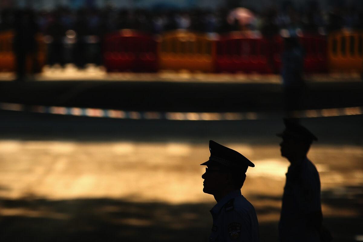 Chinese policemen stand guard in Jinan, China, on Aug. 22, 2013. (Feng Li/Getty Images)