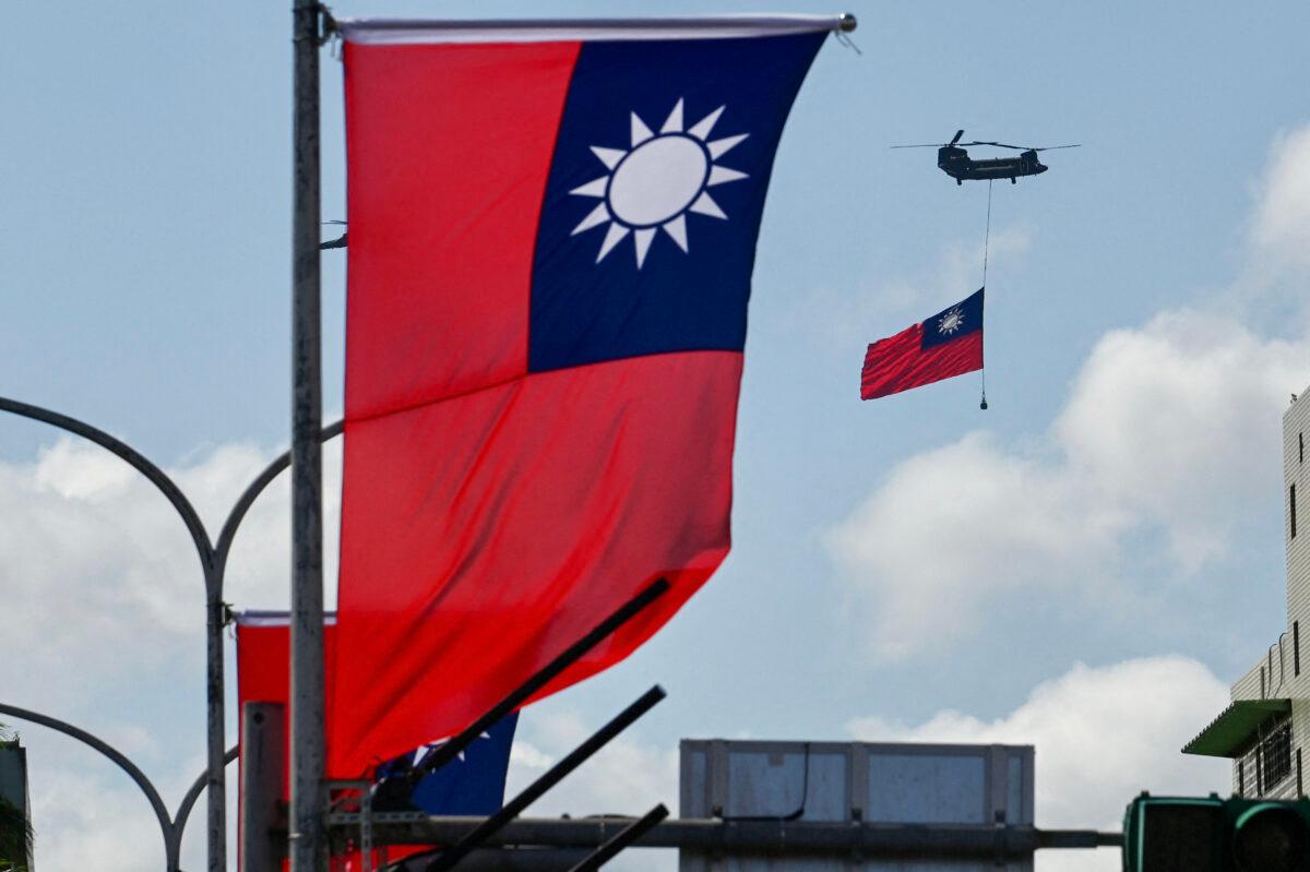 A CH-47 Chinook helicopter carries a Taiwan flag during National Day celebrations in Taipei on Oct. 10, 2021. (Sam Yeh/AFP via Getty Images)