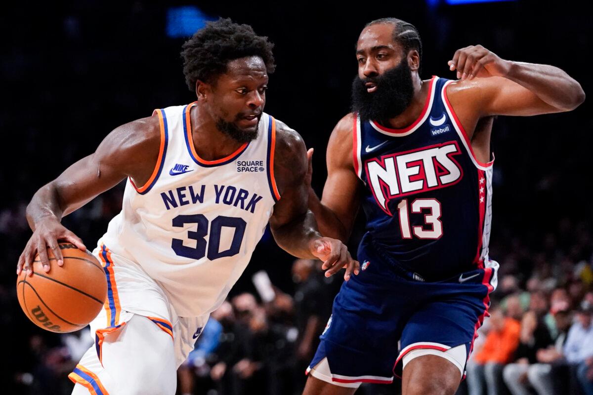 New York Knicks forward Julius Randle (30) drives against Brooklyn Nets guard James Harden (13) during the first half of an NBA basketball game, in New York, on Nov. 30, 2021. (Mary Altaffer/AP Photo)