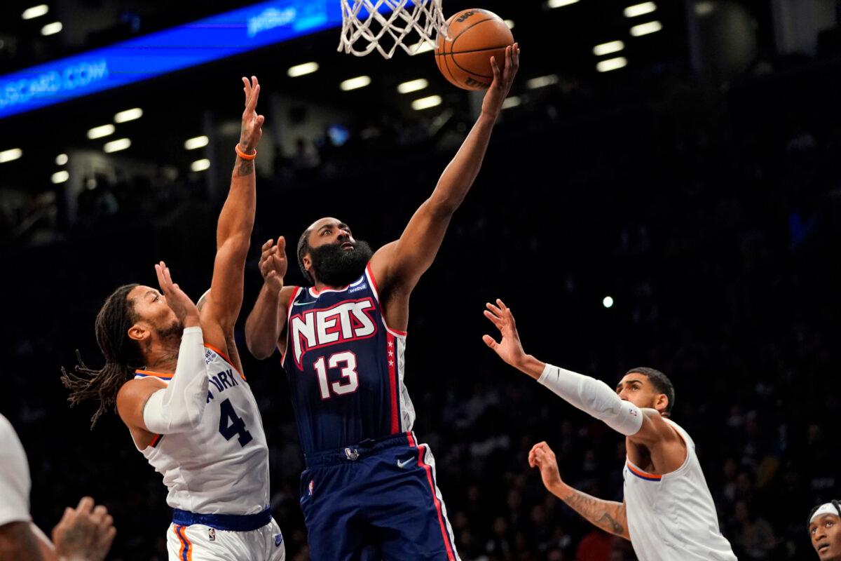 Brooklyn Nets guard James Harden (13) goes to the basket past New York Knicks guard Derrick Rose (4) during the second half of an NBA basketball game in New York, on Nov. 30, 2021. (Mary Altaffer/AP Photo)