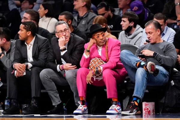 Film director Spike Lee, second from right, watches the action during the first half of an NBA basketball game between the Brooklyn Nets and the New York Knicks, in New York, on Nov. 30, 2021. (Mary Altaffer/AP Photo)