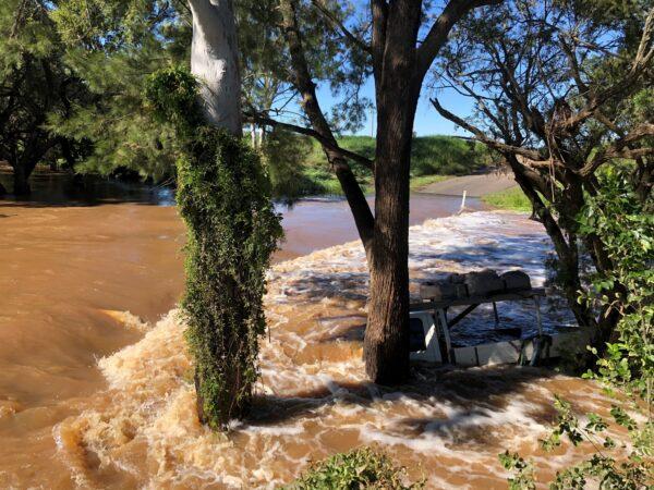 A ute is seen submerged in floodwater after its swept off a river crossing, obtained on Dec. 2, 2021. (Supplied by Queensland Fire and Emergency Services)