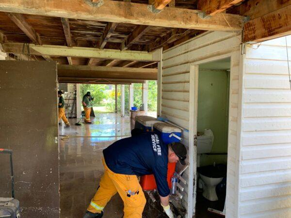 QFES crew assist after a residence is inundated, obtained Dec. 2, 2021. (Supplied by Queensland Fire and Emergency Services)