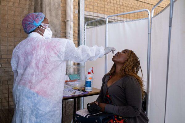 A healthcare worker conducts a PCR Covid-19 test at the Lancet laboratory in Johannesburg on November 30, 2021. (EMMANUEL CROSET/AFP Getty Images)