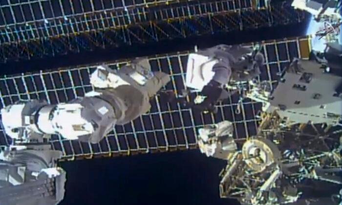Spacewalking Astronauts Replace Antenna After Debris Scare