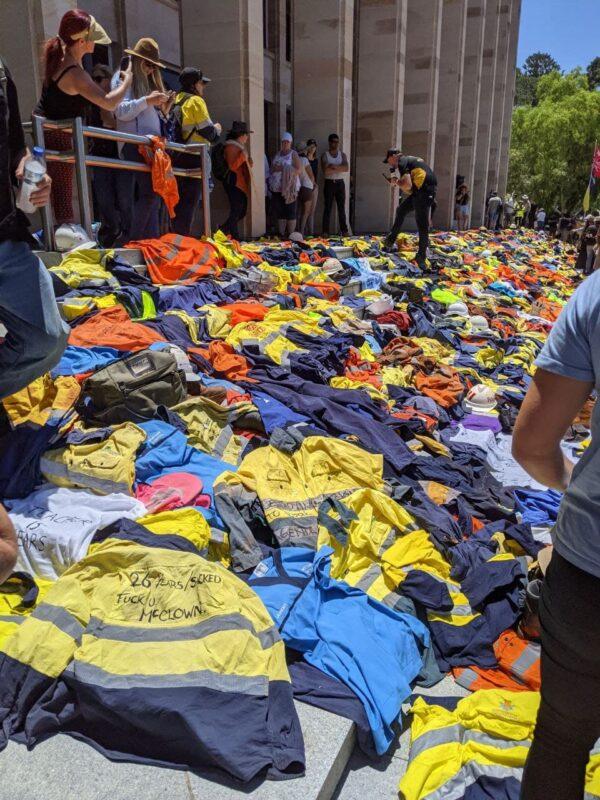 Mining and other workers lay their shirts down in front of the Western Australia Parliament House to protest vaccination mandates in Perth, Australia on Dec. 1, 2021. (The Epoch Times)