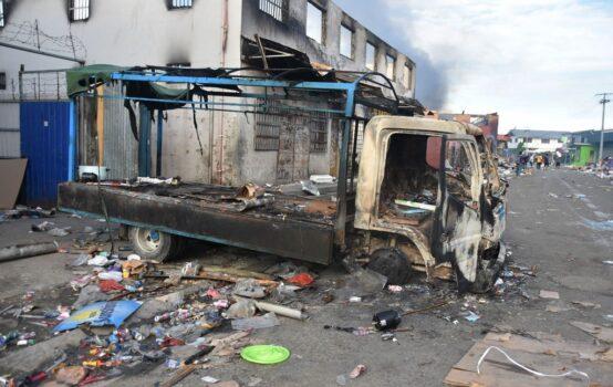 A burnt out truck sits in the Chinatown district of Honiara on the Solomon Islands on Nov. 26, 2021. (Charley Piringi/AFP via Getty Images)