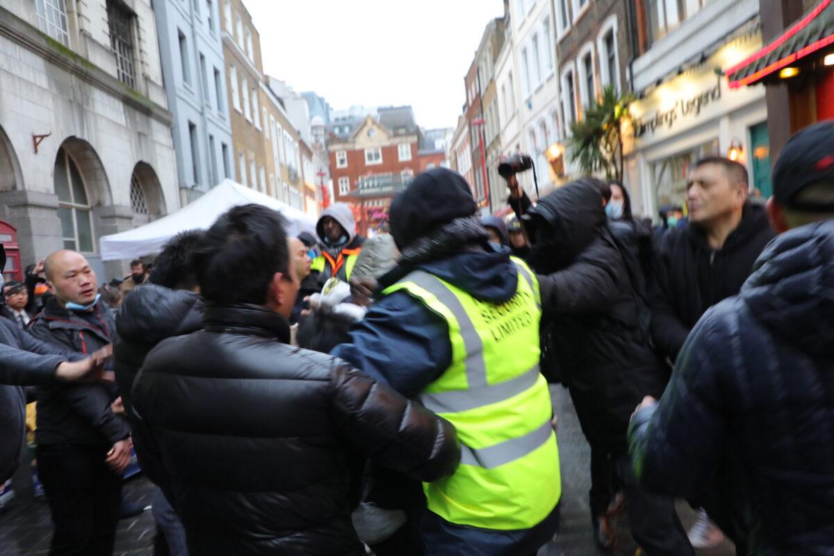 Scuffles broke out between two rallies in Chinatown in London on Nov. 27, 2021. (Wen Dongqing/The Epoch Times)
