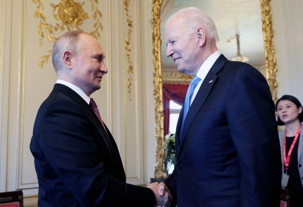 Russian President Vladimir Putin left, shakes hands with U.S. President Joe Biden during a meeting in Geneva, Switzerland on June 16, 2021. (Mikhail Metzel/Sputnik/AFP via Getty Images)