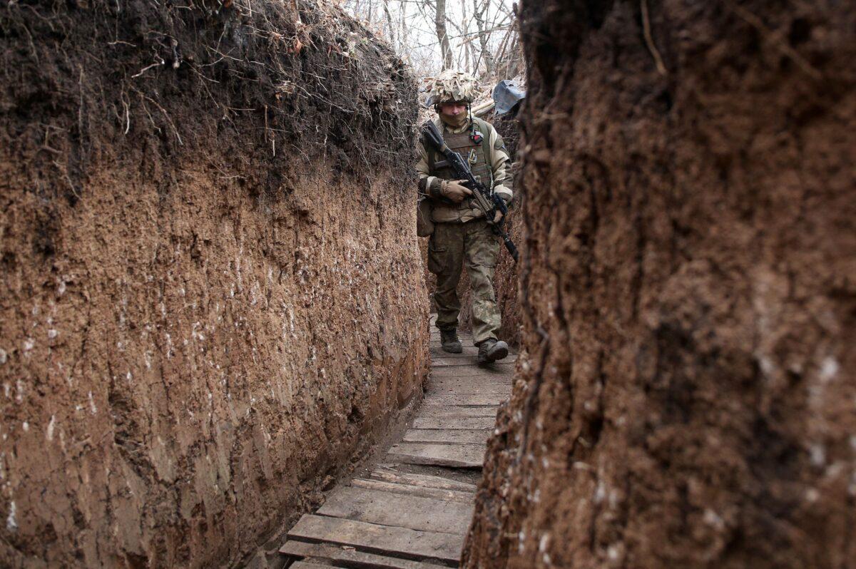 A Ukrainian serviceman walks along a trench on the front line with Russia-backed separatists near the Donetsk region on Nov. 26, 2021. (Anatolii Stepanov/AFP via Getty Images)