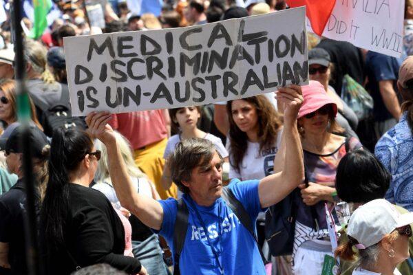 A protester holds up a placard during a rally against new pandemic laws and vaccination mandates in Melbourne, Australia, on Dec. 4, 2021. (William West/AFP via Getty Images)