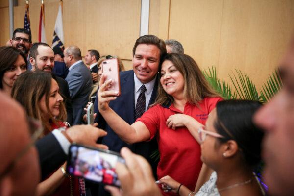 Florida Gov. Ron DeSantis mingles with the audience after signing into law Senate Bill 7072 at Florida International University in Miami on May 24, 2021. (Samira Bouaou/The Epoch Times)