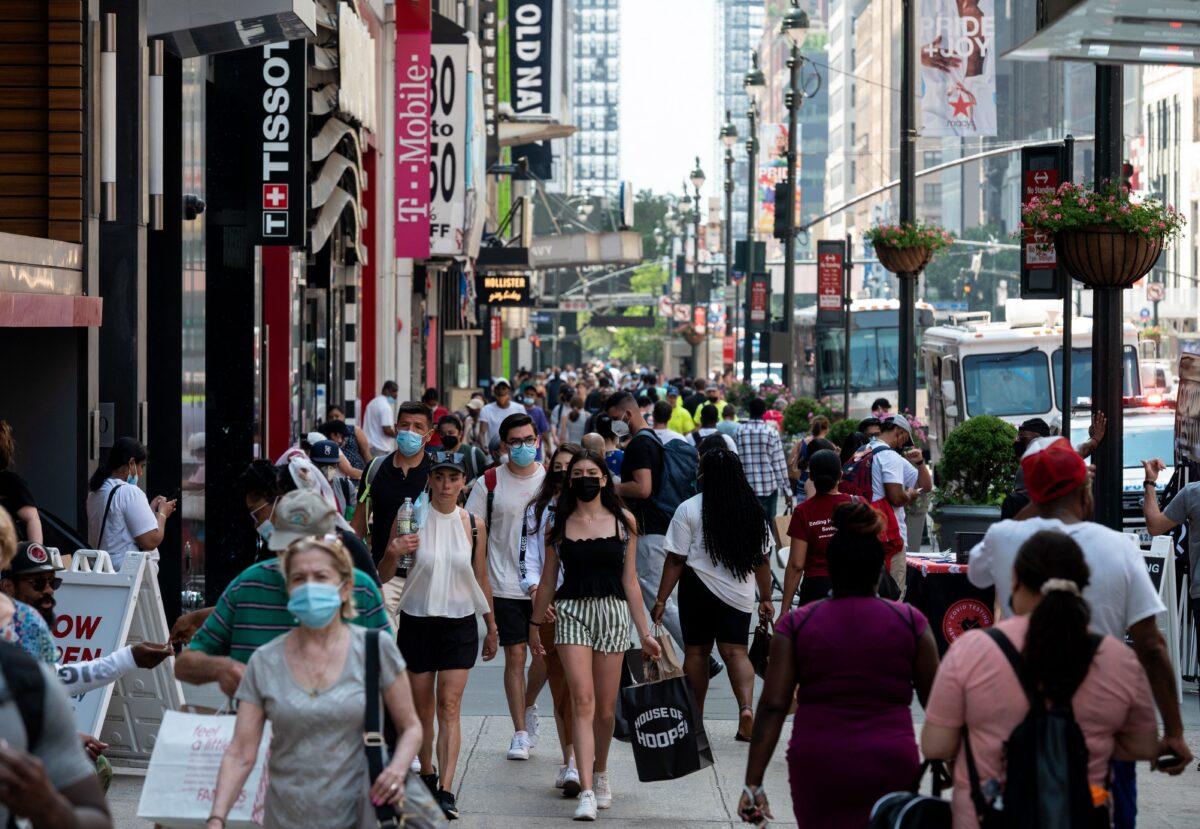 People walk through a shopping area in Manhattan in New York on Jun. 7, 2021. (ANGELA WEISS/Getty Images)