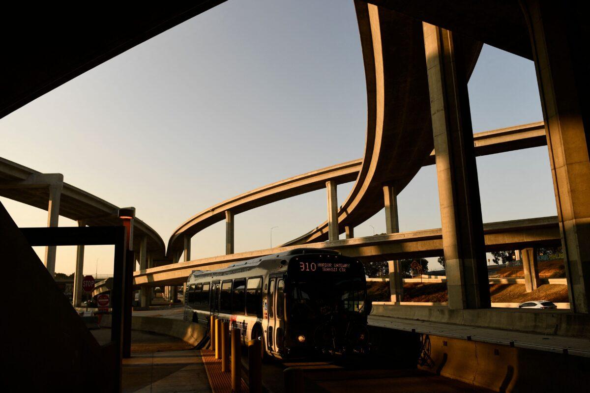 A Metro Silver Line bus drives on the 110 Freeway under the Judge Harry Pregerson Interchange with the 105 Freeway during rush hour traffic in Los Angeles, California on Jul. 16, 2021. (PATRICK T. FALLON/ Getty Images)