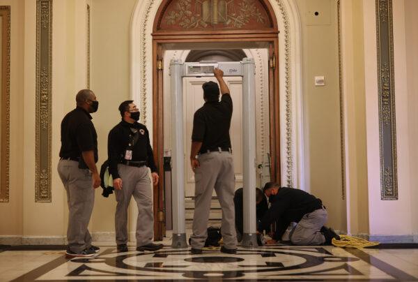 U.S. Capitol Police install a metal detector outside the House of Representatives Chamber in Washington on Jan. 12, 2021. (Chip Somodevilla/Getty Images)