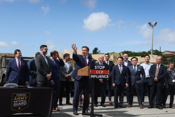 Florida Gov. Ron DeSantis signs two bills to combat foreign influence and corporate espionage in Florida from governments like China, surrounded by state, local, and Taiwanese representatives at the Florida National Guard Robert A. Ballard Armory in Miami on June 07, 2021. (Joe Raedle/Getty Images)