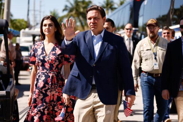 Gov. Ron DeSantis and his wife, Casey, arrive to visit a memorial to those missing outside the 12-story Champlain Towers South condo building that partially collapsed in Surfside, Fla., on July 3, 2021. (Michael Reaves/Getty Images)
