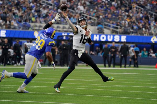 Jacksonville Jaguars quarterback Trevor Lawrence (16) throws over Los Angeles Rams defensive end Aaron Donald (99) during the first half of an NFL football game in Inglewood, Calif., on Dec. 5, 2021. (Mark J. Terrill/AP Photo)