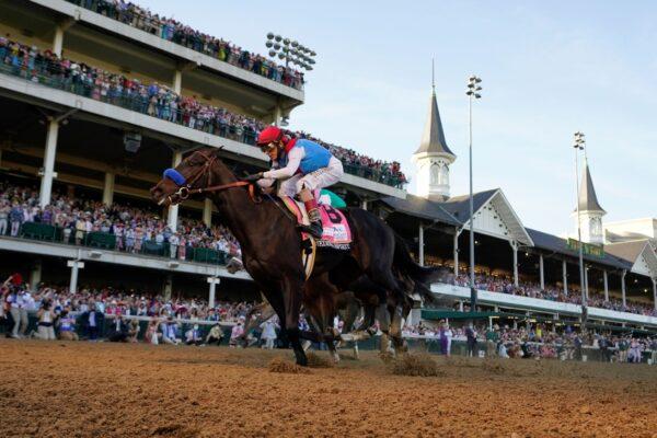 John Velazquez rides Medina Spirit across the finish line to win the 147th running of the Kentucky Derby at Churchill Downs in Louisville, Ky., on May 1, 2021. (Jeff Roberson/AP Photo)
