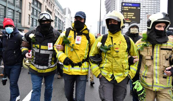 Firemen march during a protest against CCP virus restrictions in Brussels, on Dec. 5, 2021. (Geert Vanden Wijngaert/AP Photo)