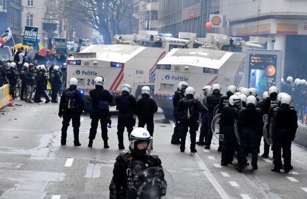 Riot police officers deployed to block the street during a protest against CCP virus measures in Brussels, on Dec. 5, 2021. (Geert Vanden Wijngaert/AP Photo)