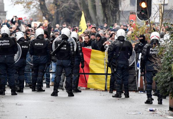 Riot police block a street during a protest against CCP virus measures in Brussels, on Dec. 5, 2021. (Geert Vanden Wijngaert/AP Photo)