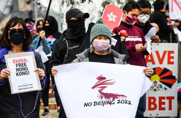 Activists, including members of the local Hong Kong, Tibetan, and Uyghur communities hold up banners and placards in Melbourne, Australia, on June 23, 2021, calling on the Australian government to boycott the 2022 Beijing Winter Olympics over China's human rights record. (William West/AFP via Getty Images)