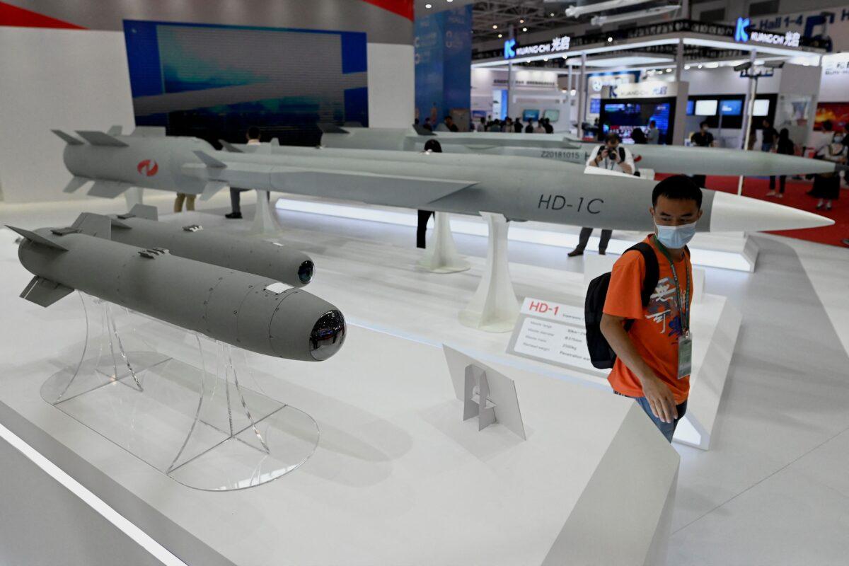 A man walks among supersonic cruise missiles at the 13th China International Aviation and Aerospace Exhibition in Zhuhai in southern China's Guangdong Province on Sept. 28, 2021. (Noel Celis/AFP via Getty Images)