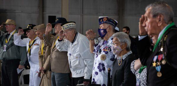 Pearl Harbor survivors and World War II veterans, along with family and friends, render honors during the National Anthem at the 80th Anniversary Pearl Harbor Remembrance in Pearl Harbor, Hawaii, on Dec. 7, 2021. (U.S. Navy photo by Mass Communication Specialist 1st Class Jessica Gray)