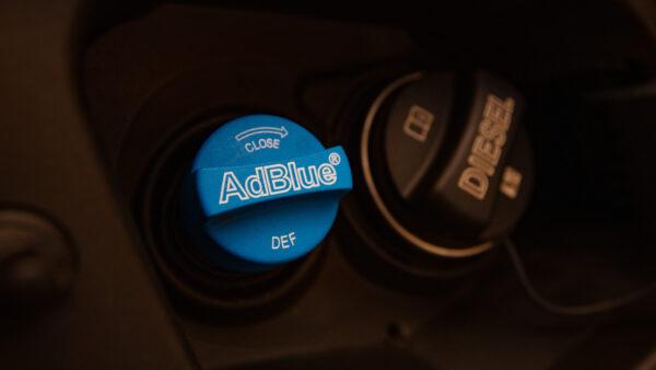 Closeup of AdBlue and diesel caps in a car. (Ruslan/Adobe Stock)