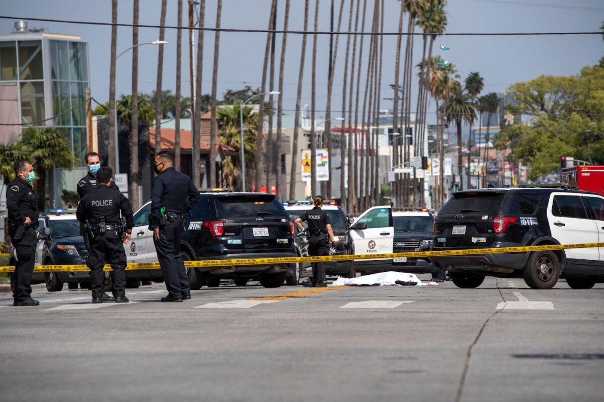 LAPD police officers stand at the scene of a fatal shooting involving police on the corner of Fairfax Avenue and Sunset Boulevard in Los Angeles on April 24, 2021. (Valerie Macon/AFP via Getty Images)
