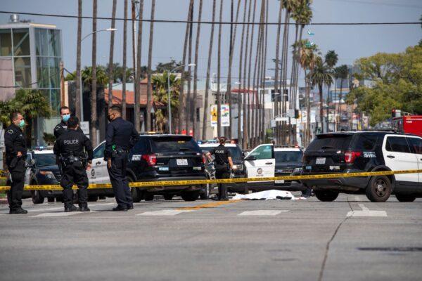 LAPD police officers at the scene of a fatal shooting involving police on the corner of Fairfax Avenue and Sunset Boulevard, Los Angeles, on April 24, 2021. (Valerie Macon/AFP via Getty Images)